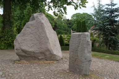 Jelling runestones. To the left is "Denmark's birth certificate," on the right Gorm's memory stone for his wife, Thyra.